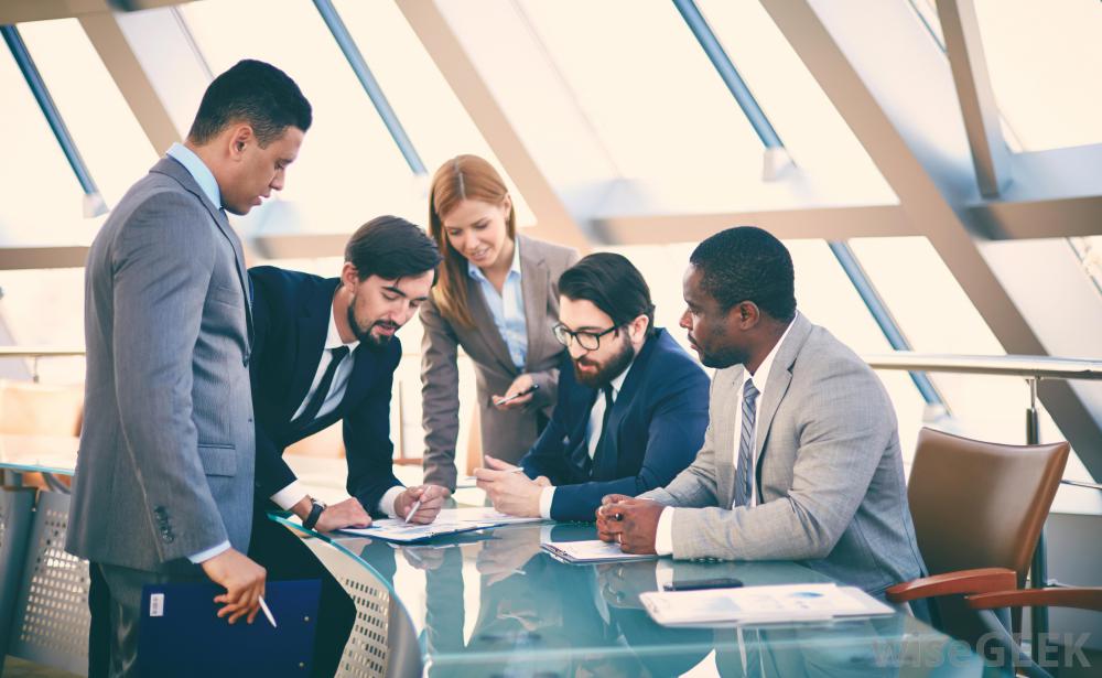 Consultants reviewing plans together around a meeting table