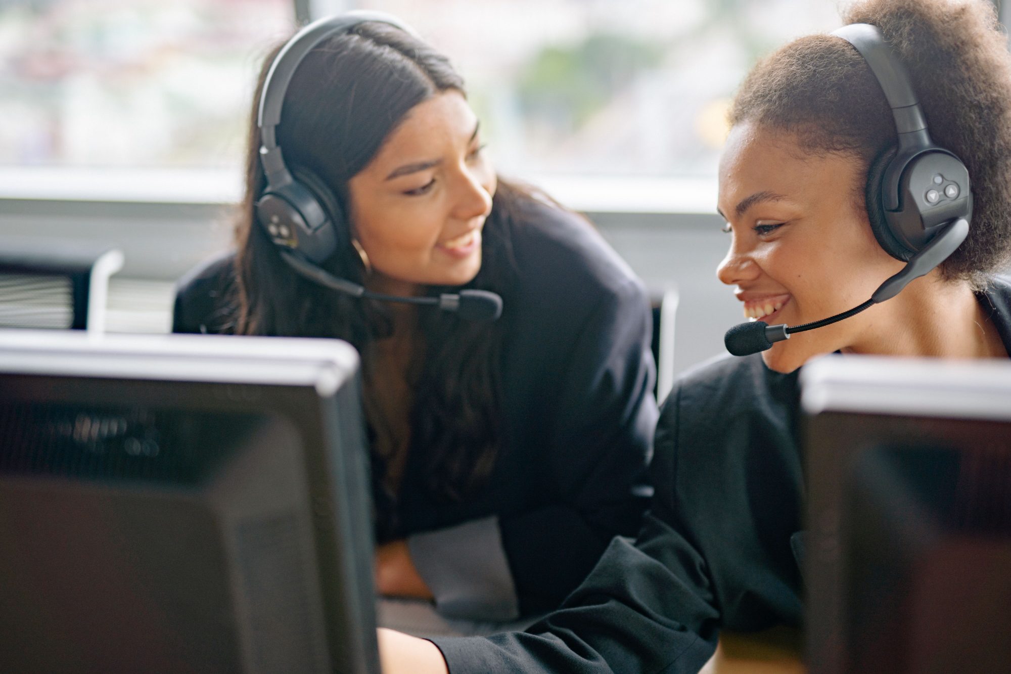 Support desk team wearing headsets at their workstations